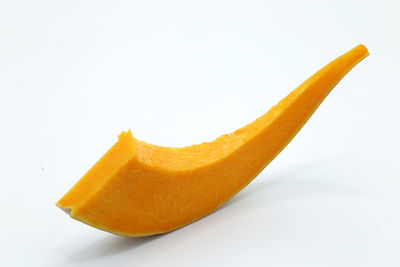 Close-up of orange fruit against white background