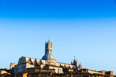 Low angle view of buildings against blue sky