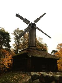 Low angle view of traditional windmill against sky