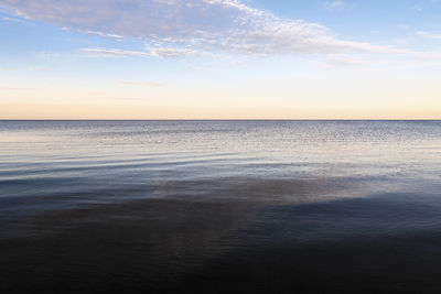 Scenic view of sea against sky during sunrise.