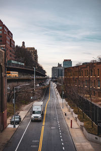 High angle view of road by buildings against sky