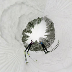 People skiing on snowcapped mountain during winter