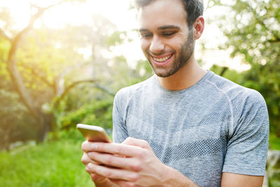 Portrait of young woman using mobile phone