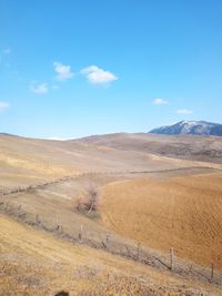 Scenic view of arid landscape against sky