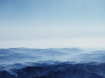 Scenic view of mountains against blue sky