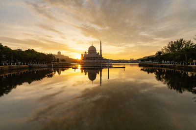 Reflection of temple in water at sunset