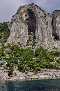 Rock formations by sea against sky