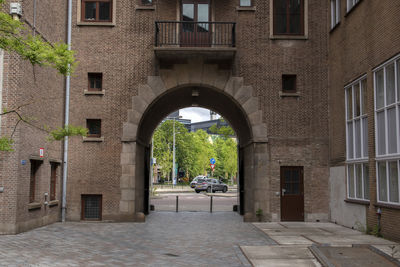 Footpath amidst buildings in city