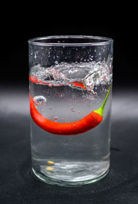 Close-up of drink on glass against black background