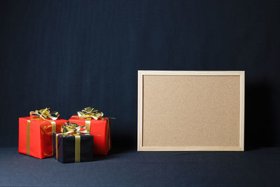 Close-up of red box on table against black background