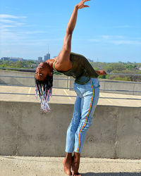 Full length of woman climbing on wall