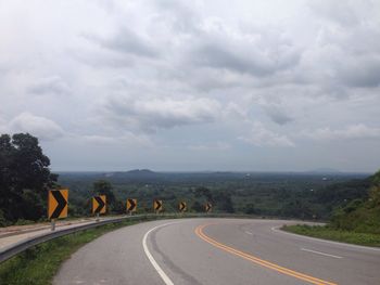 Road passing through landscape against sky