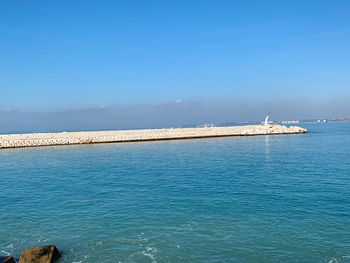 Scenic view of sea against clear blue sky