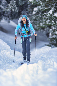 Man with umbrella on snow against mountains