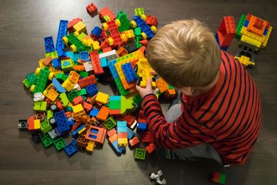 Rear view of boy playing with toy blocks