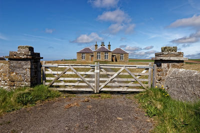 Built structure on field against sky