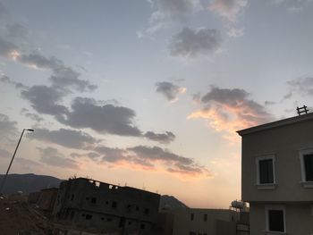 Low angle view of silhouette buildings against sky during sunset