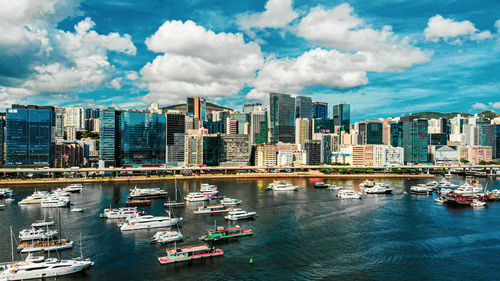 Panoramic view of bay and buildings against sky