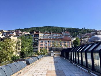 Houses in town against clear sky