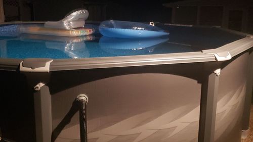 Chairs and table by swimming pool