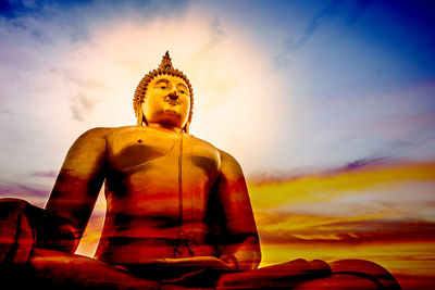 Low angle view of statue against sky at sunset