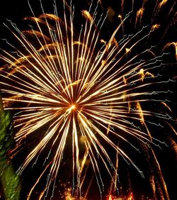 Low angle view of firework display at night