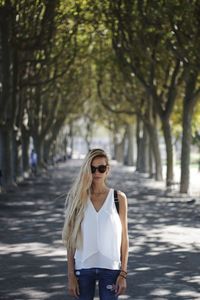 Young man wearing sunglasses on road