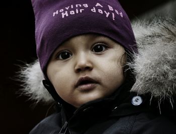 Close-up portrait of girl wearing warm clothing