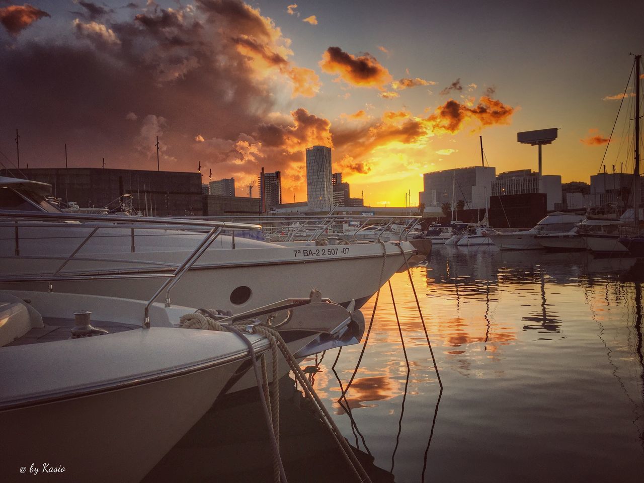 transportation, sunset, mode of transport, nautical vessel, water, building exterior, architecture, sky, moored, boat, built structure, orange color, city, cloud - sky, river, harbor, reflection, car, dusk, travel