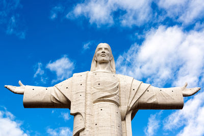 Low angle view of cristo de la concordia against sky