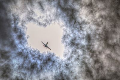 Low angle view of airplane flying in sky