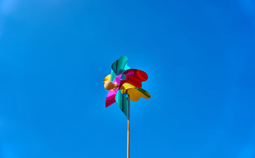 Close-up of red toy against blue sky