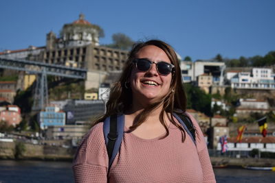 Portrait of smiling woman in city