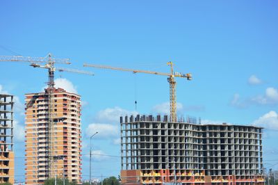 Low angle view of buildings against blue sky