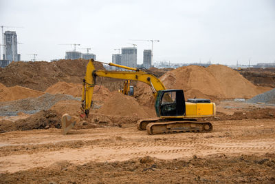 Excavator during earthworks at construction site. backhoe digging the ground for the foundation.