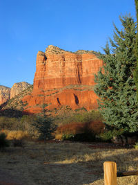 Rock formations on landscape against blue sky