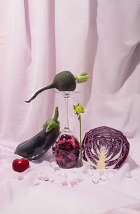 Eggplant, black radish and purple cabbage on light violet curtain. healthy food concept. still life
