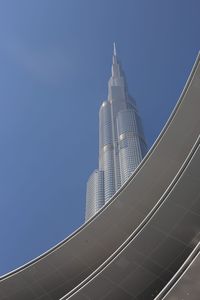 Low angle view of modern building against clear blue sky