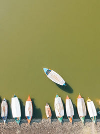 High angle view of colorful boats moored at lakeshore