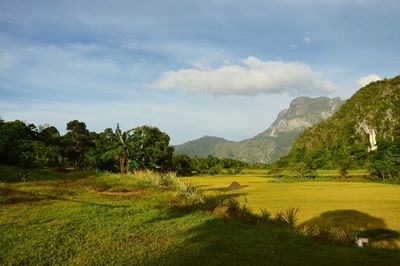 Scenic view of mountains against cloudy sky