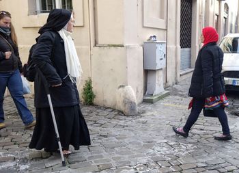 Rear view of people walking on street