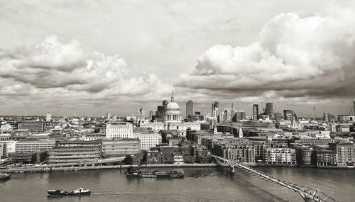 Panoramic view of cityscape against cloudy sky