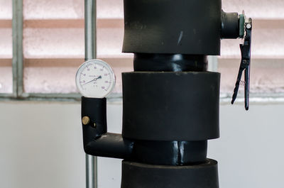 Close-up of pressure gauge against wall