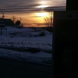 Scenic view of snow covered landscape at sunset