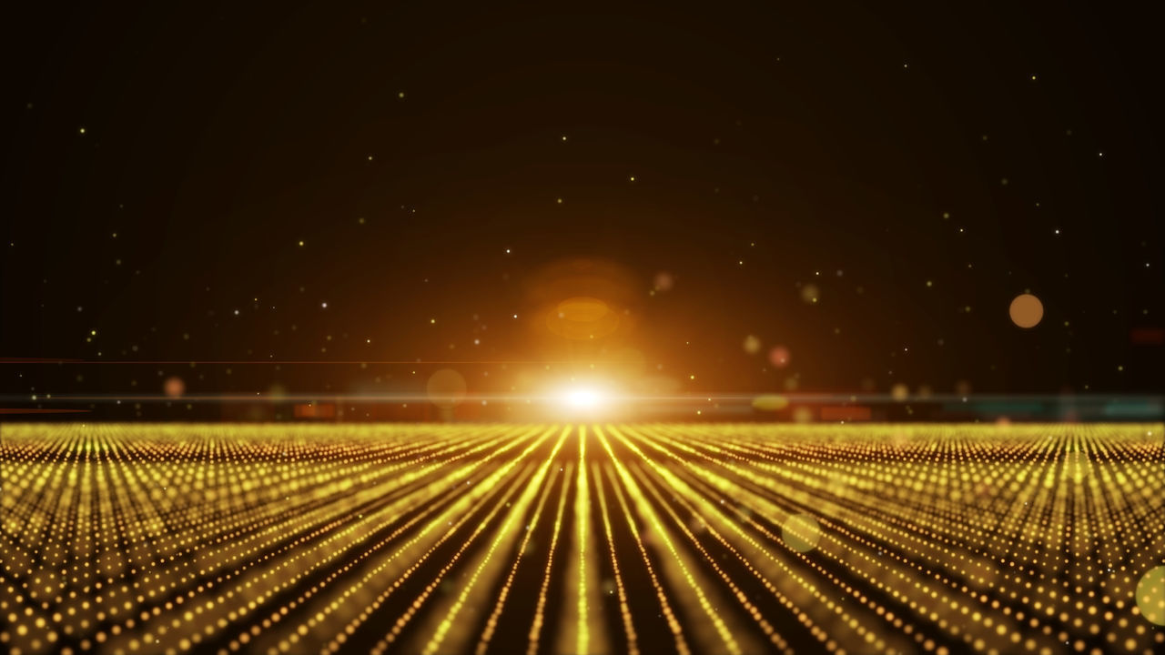 ILLUMINATED RAILROAD TRACKS AGAINST SKY DURING NIGHT