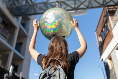 Optical illusion of woman holding crystal ball