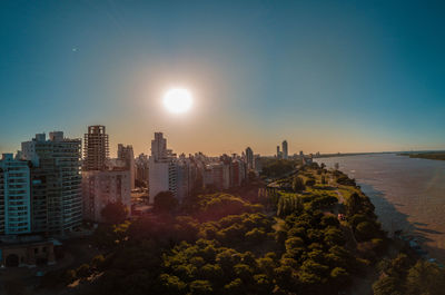 High angle view of buildings by sea against sky