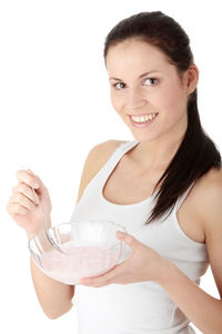 Portrait of a smiling young woman against white background