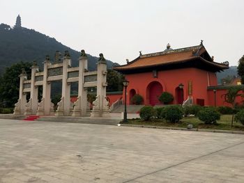 Facade of temple building against clear sky