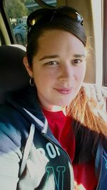 Portrait of a young woman sitting in train